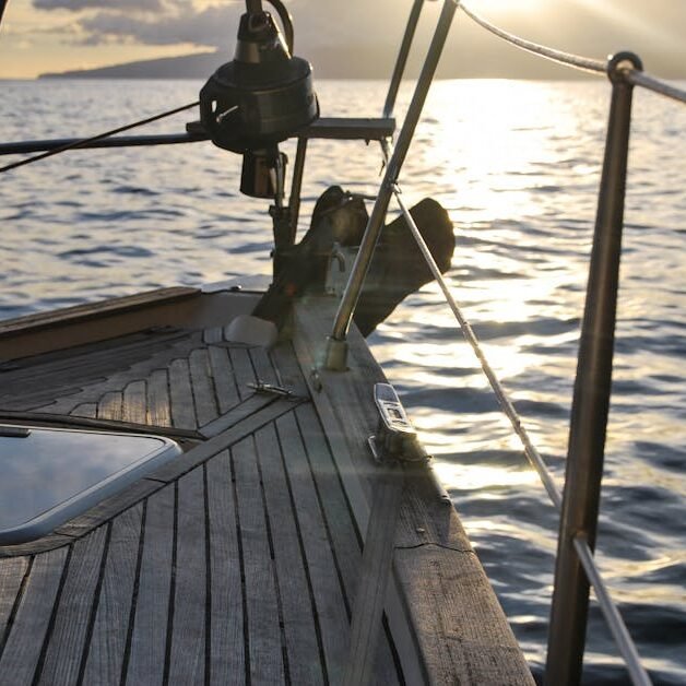 Experience serene sailing at sunset aboard a yacht navigating open waters.