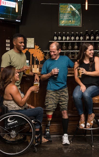 Friends with disabilities enjoying craft beers and socializing in a cozy bar.